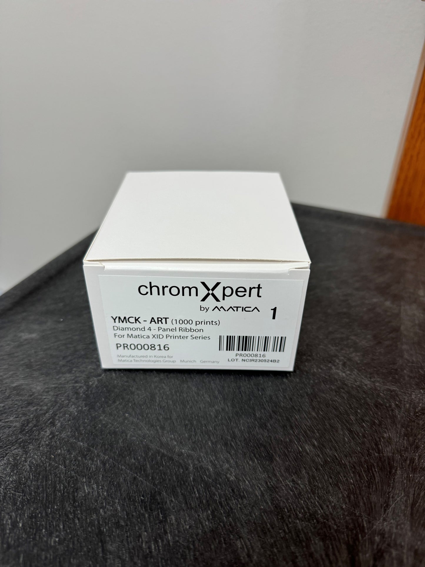White box labeled 'chromXpert by Matica' on a dark surface with a neutral background
